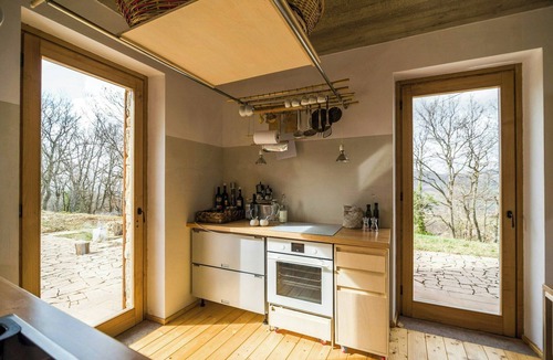 Montebuono House | Stone farmhouse among oaks in Maremma