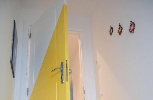 Fuorigrotta Apartment | Yellow apartment with double bedroom and living room / kitchen with sofa bed and private bathroom