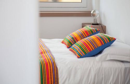 Fuorigrotta Apartment | Yellow apartment with double bedroom and living room / kitchen with sofa bed and private bathroom