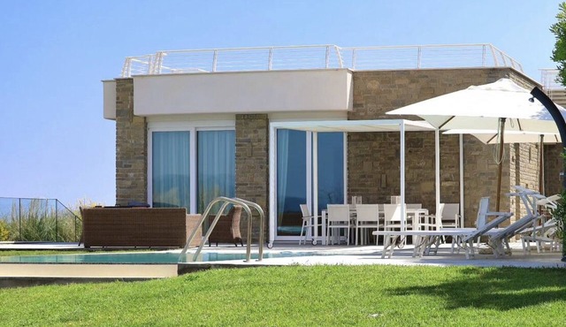 Design beachfront villa, private pool, a/c, WiFi, garden and parking space