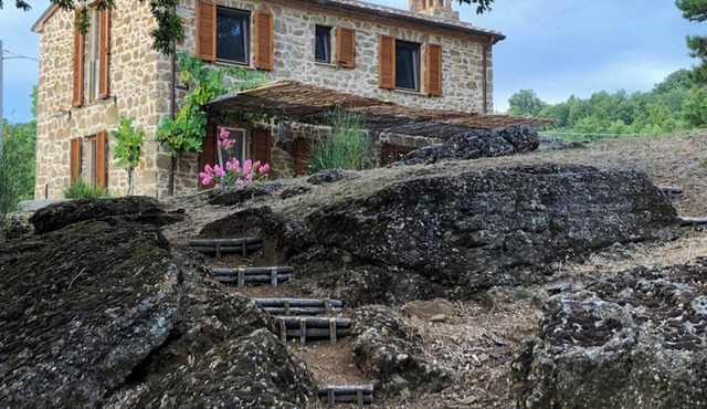 Stone farmhouse among oaks in Maremma